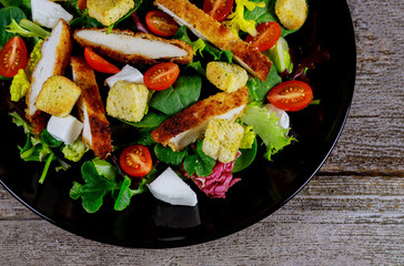 Wall Mural - Chicken salad with cherry tomatoes and lettuce food healthy meal close up.