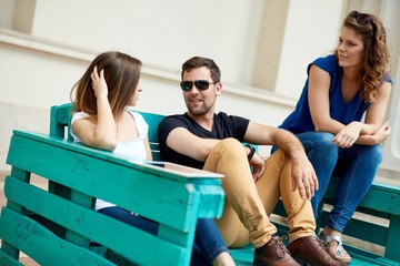 Wall Mural - Young people sitting outdoors