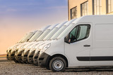 Fototapeta Most - commercial delivery vans parked in row. Transporting service company.