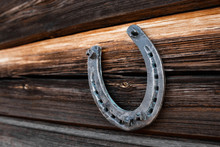 Old Horseshoe On An Old Wooden Board. The Concept Of Luck, Luck, Luck.