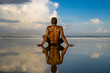 © TheVisualsYouNeed - young attractive and relaxed black afro American man with fit body and muscular back sitting on beach sand enjoying beautiful view thinking and meditating free