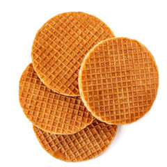 Pile of caramel  round Dutch waffles isolated on white background. Top view