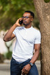 © Samuel B. - Outdoor portrait of a Young black African American young men talking  on mobile phone