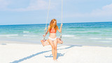 Fototapeta Łazienka - Red haired girl in bikini swinging on the beautifyl beach with white sand and crystal water in Phu quoc island Vietnam ,travel concept