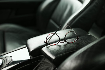 Wall Mural - glasses in the leather car interior