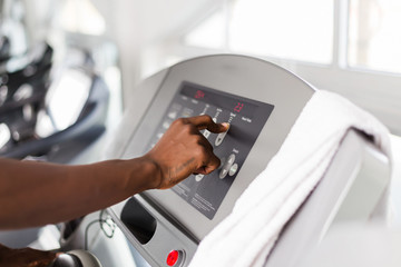 Wall Mural - Black African American  young man doing cardio workout at the gym