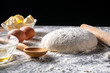 © k_samurkas - White flour with eggs, butter and dough on a cooking board