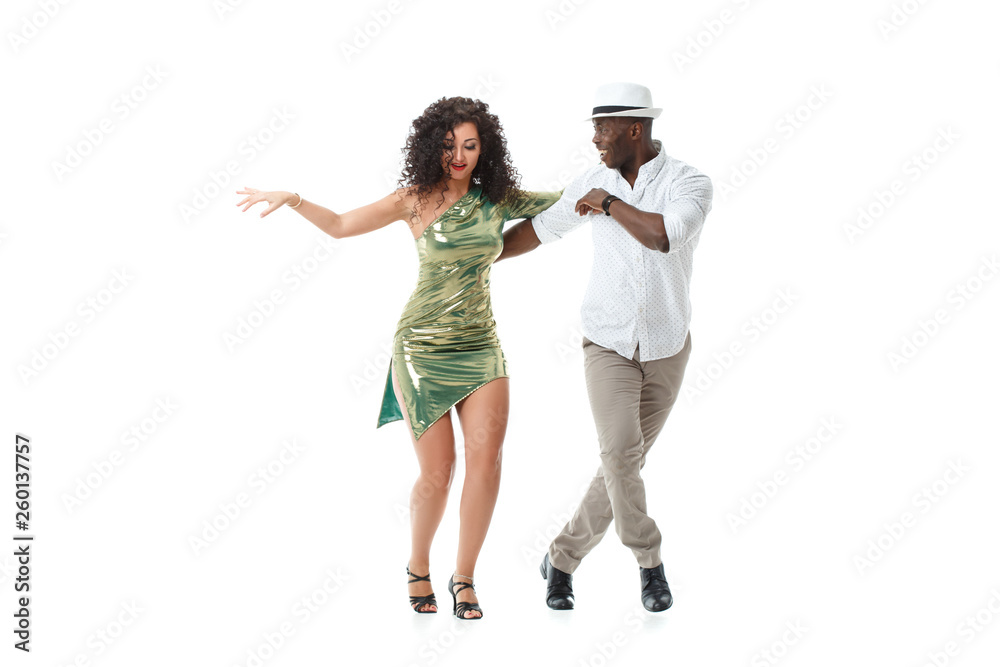Elegant black man and gorgeous latin girl dancing samba isolated on white background. - obrazy, fototapety, plakaty 