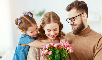 happy mother's day! father and child congratulate mother on holiday  .