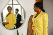 © prostooleh - Handsome man in a black suit. Woman in a yellow jacket. Businessman working in a office