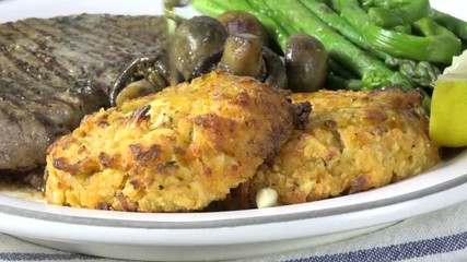 Poster - Pouring a lemon butter sauce over lobster cakes