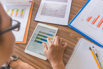 Office man reading financial number on tablet