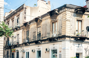 Traditional architecture of Sicily in Italy, historical street of Catania, facade of old buildings.