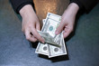 © polack - Woman hands hold and counting dollar banknotes