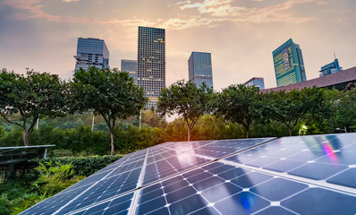 ecological energy renewable solar panel plant with urban landscape landmarks