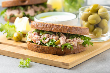 Wall Mural - Sandwich with tuna, olives and lemon. Delicious lunch, healthy food, snack with fish on crispy toast