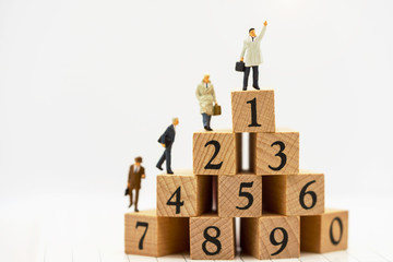 Wall Mural - Miniature people: Business people standing on wooden box with top of ranking. Business career growth,  achievement, success., victory or top ranking Concept.