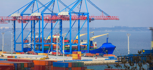 Wall Mural - Container Ship is loading in a sea port  Odessa. Work of the container terminal for shipping goods.