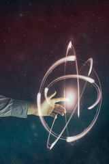Leinwandbilder - Man forefinger touches yellow atom. Mixed media.