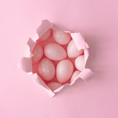 Wall Mural - pink easter eggs with pink paper hole. minimal easter background composition. flat lay.