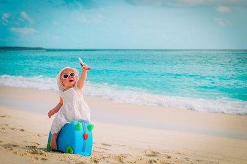 cute little girl travel on summer beach