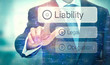 © Duncan Andison - A business man selecting a button on a futuristic display with a Liability concept written on it.