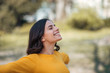© bnenin - Close-up image of a young woman relaxing in the park in the springtime.