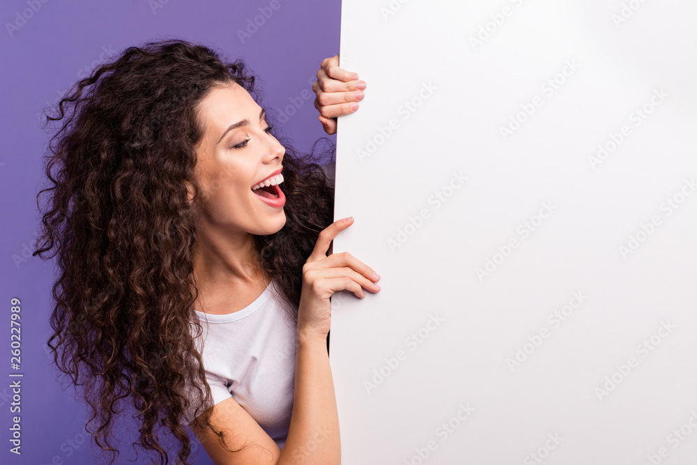 Close-up portrait of nice cute attractive charming cheerful cheery brunette wavy-haired lady showing looking aside large ad advert isolated over bright vivid shine violet purple background - obrazy, fototapety, plakaty 