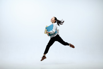 getting faster and stronger. happy woman working at office, jumping and dancing in casual clothes or