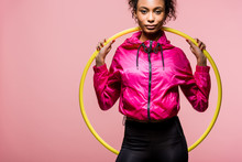 Beautiful African American Sportswoman Looking At Camera And Holding Hula Hoop Isolated On Pink With Copy Space