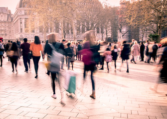 Wall Mural - Motion blurred crowds of people in busy street scene