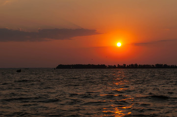 beautiful view of sun rising over water, dawn early in morning