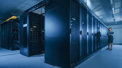 Aufkleber - In Data Center: Female IT Technician Running Maintenance Programme on a Laptop, Controls Operational Server Rack Optimal Functioning. Modern High-Tech Telecommunications Operational Data Center.