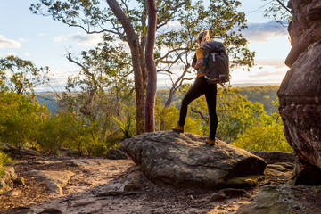 female bushwalker with backpack walking in australian bushland