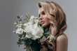 © irinaneva - beautiful sexy blonde bride posing in a sparkling wedding dress with bouquet. advertising space