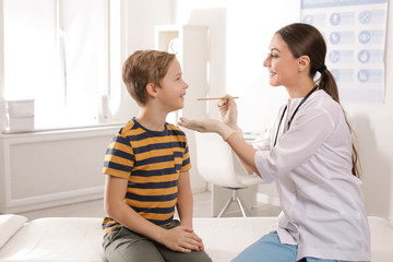 Wall Mural - Doctor examining adorable child in hospital office