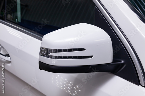 Front Mirror View Of Luxury Very Expensive New White Car Stands In Very Expensive New White Car Stands