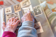 © jovannig - Elderly couple hands looking at old pictures album at home. Detail on hands and old images