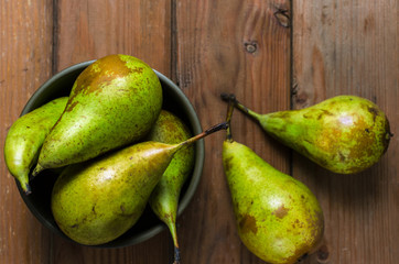 Fresh juicy Pears Conference in a bowl on a wooden rustic background.