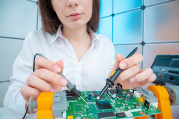 Poster - Girl with measuring devices in the electronics laboratory