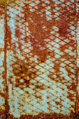 Wall Mural - Texture of rusty metal, painted white which became orange from rust. Vertical texture of rusty pattern on paint in form of steel net on steel sheet