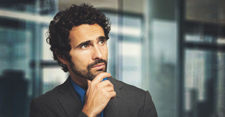 Poster - Young businessman in a thoughtful expression