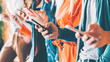 © golubovy - Millennials in digital age. Cropped closeup of smartphones in young people hands. Youth addicted to social networking services.