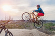 © mihakonceptcorn - A man on a mountain bike performing a dirt jump. Active lifestyle.
