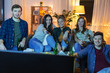 © Syda Productions - friendship and leisure concept - happy friends with non-alcoholic drinks watching tv at home in evening