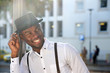 © mimagephotos - Close up handsome young african american man with suspenders and hat smiling in city
