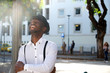 © mimagephotos - trendy young african american man with hat laughing in city