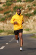 © mimagephotos - Full body healthy young african american man running on street