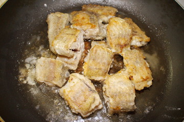 fried fish cooking in a pan