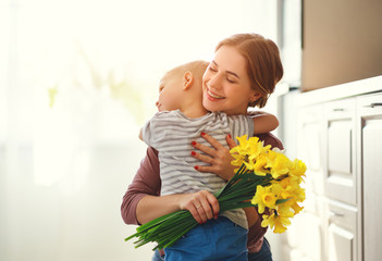 Wall Mural - happy mother's day! child son gives flowersfor mother on holiday .